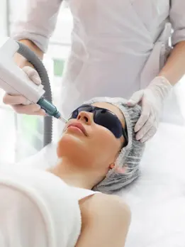 A woman undergoing a laser treatment at a salon, ensuring safety and security for the procedure.