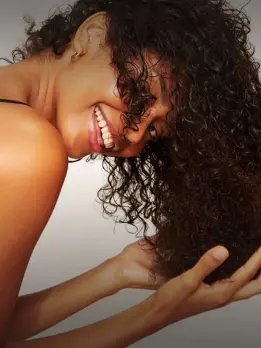Observe the radiant smile and infectious happiness of a curly-haired woman Long-Term Results.