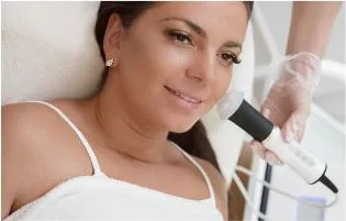 A woman getting upper lip hair removal treatment from a skin care specialist in a clinical set-up.