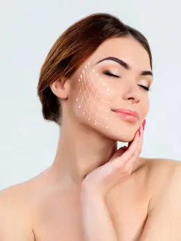 After getting perfect skin care treatment, a woman's white face sparkles against a white background.