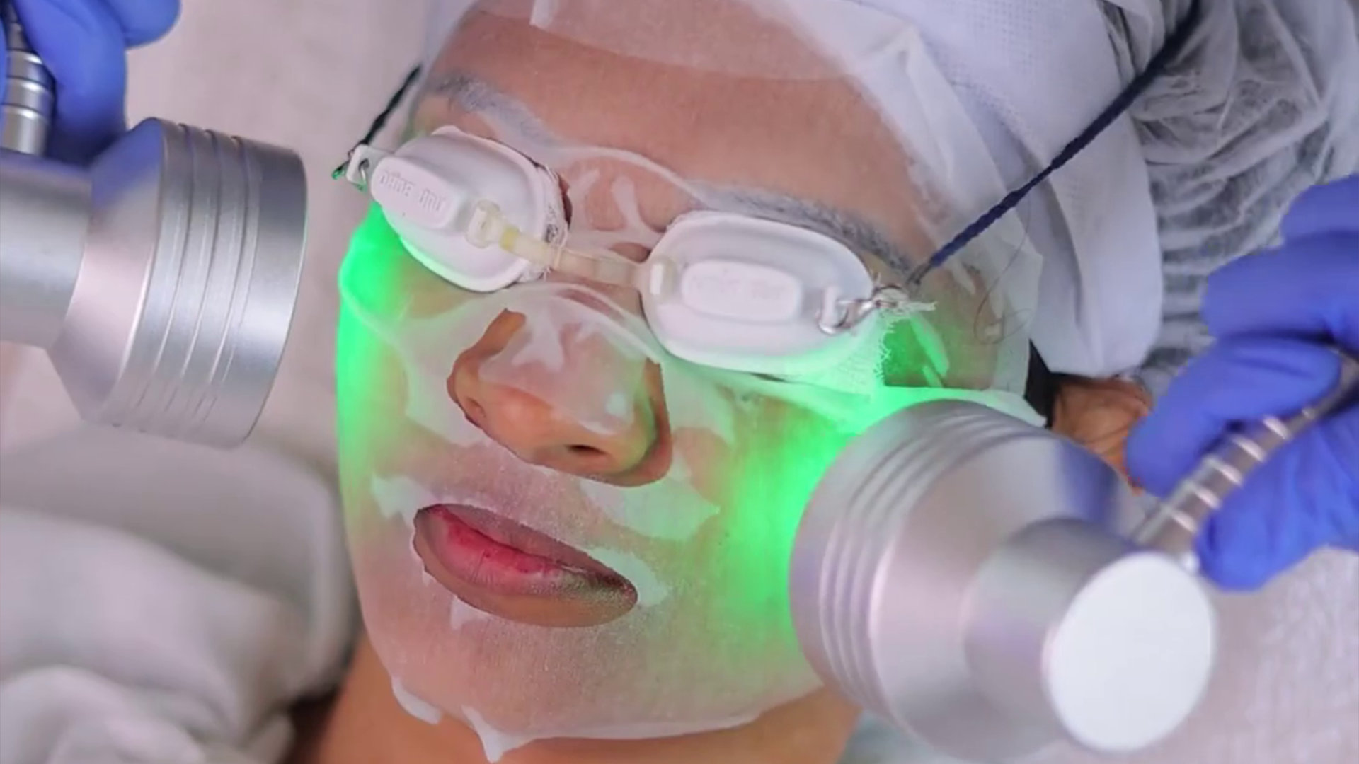 Person receiving advanced facial treatment with LED therapy