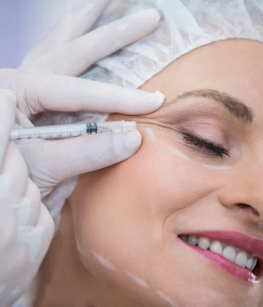  A woman receiving botox injections from a cosmetic care specialist to get wrinkle-free skin.