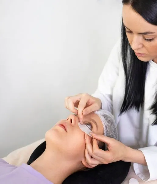 Dermatology is treating a woman who undergoes treatment to get rid of black circles on her face.