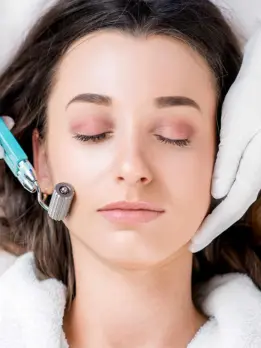 A machine is providing a woman with a safe and effective facial treatment for skin rejuvenation.